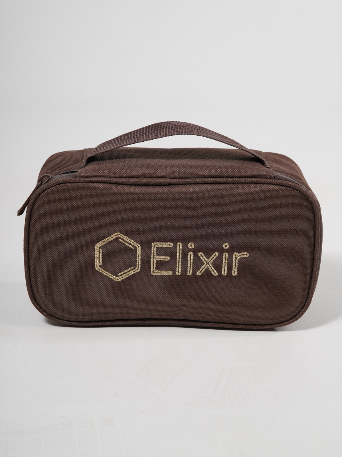 The Case — the Elixir bag, embossed with the gold mark
